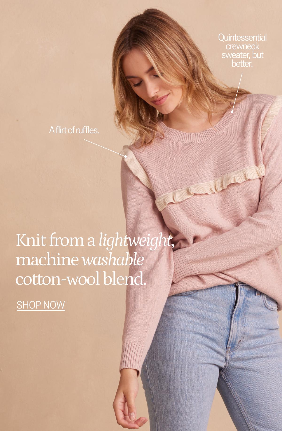 Model wearing pink ruffle sweater