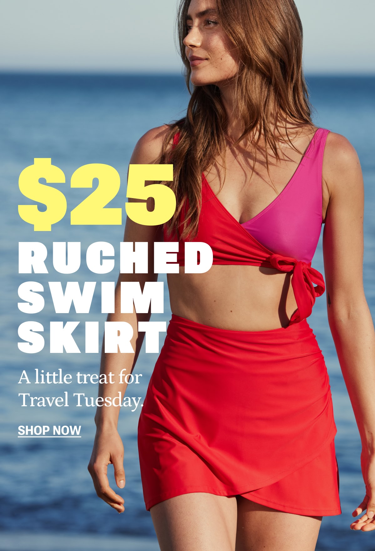 Model in pink and red bikini top and matching swim skirt