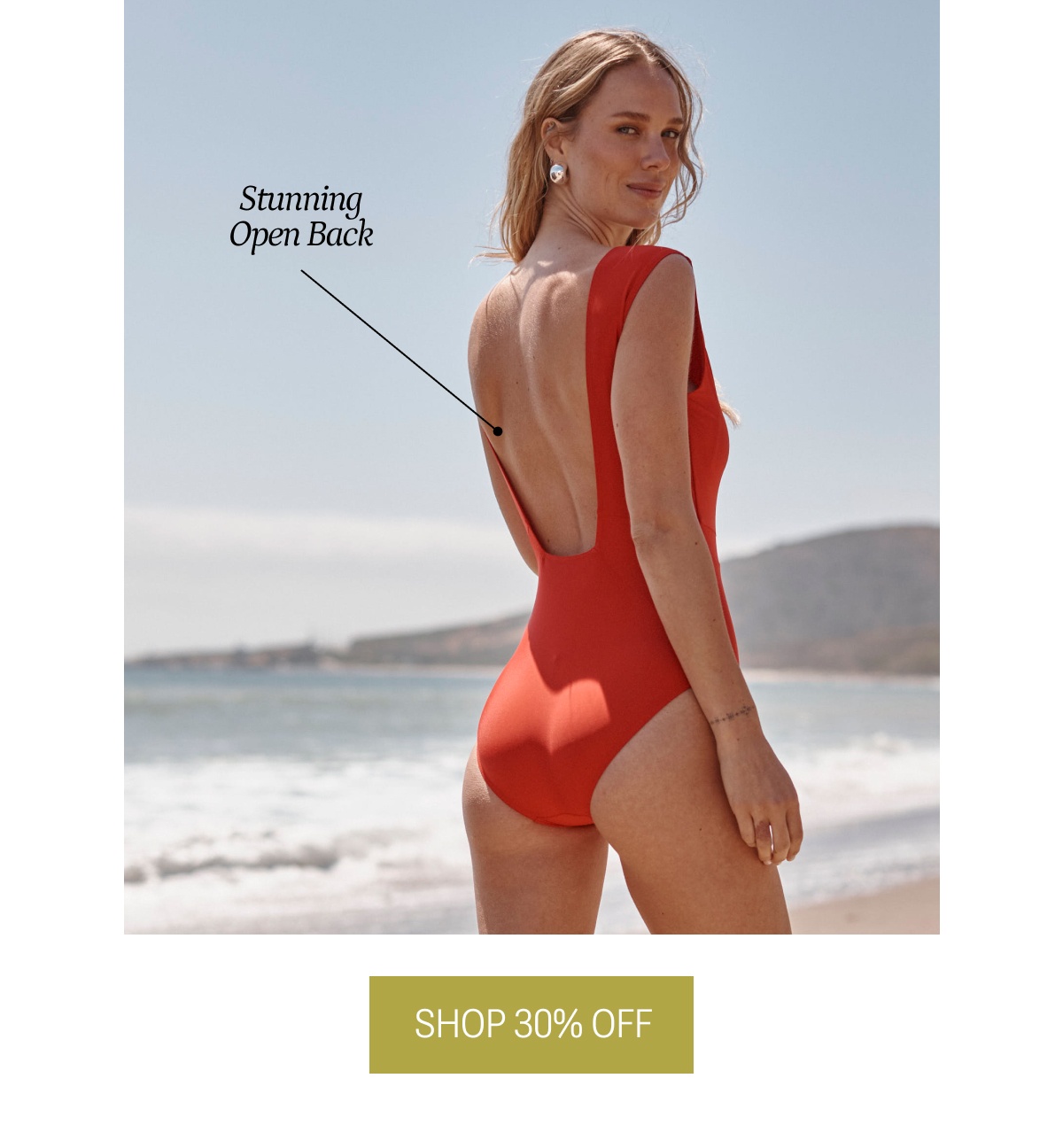 Model in red, open back one piece swimsuit