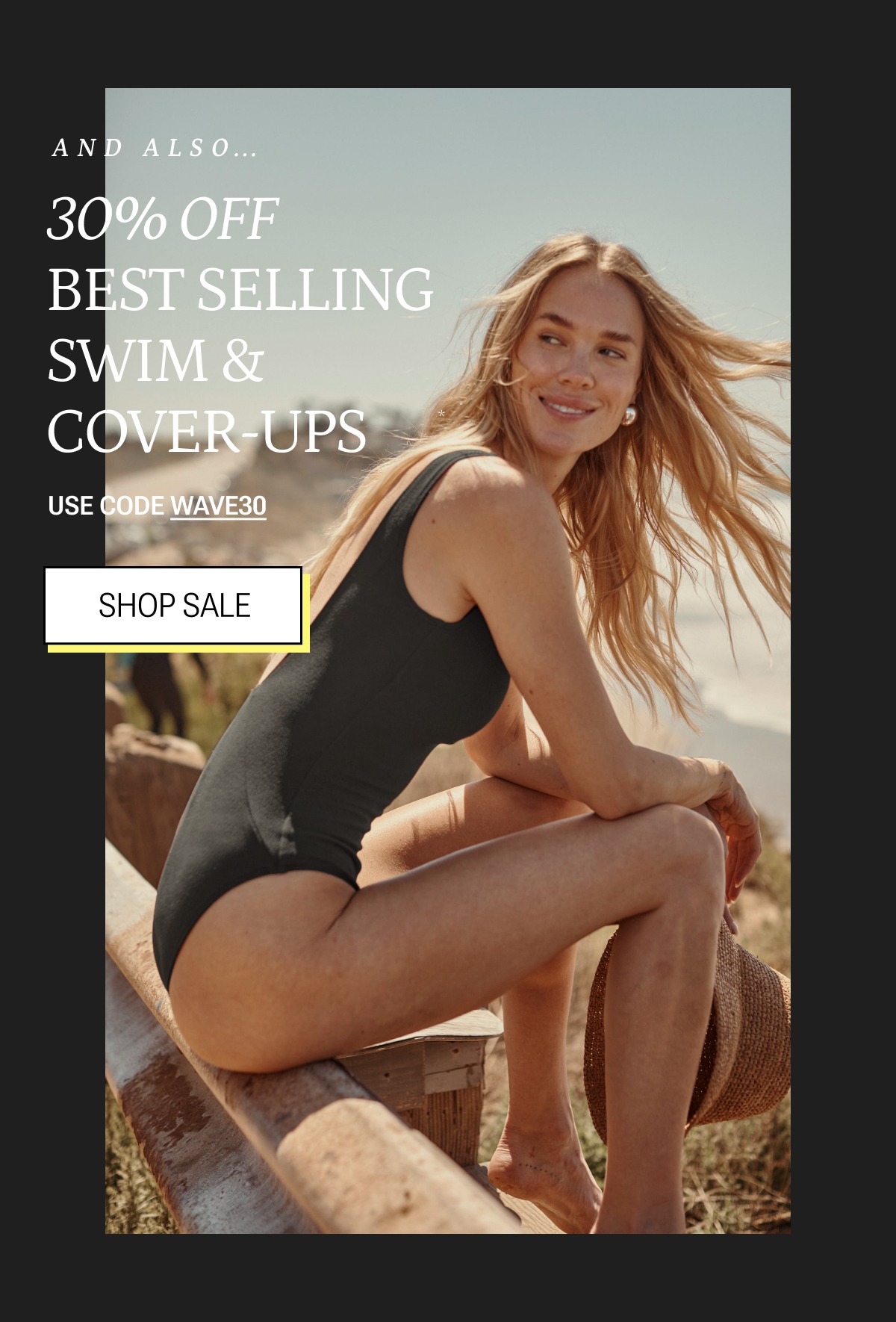 Model in black one piece swimsuit