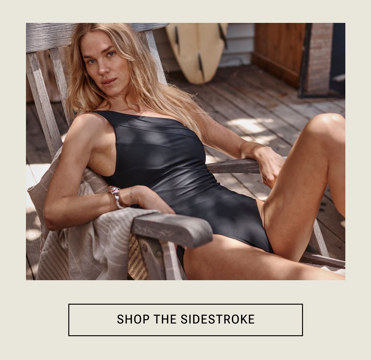 Model in black one piece swimsuit