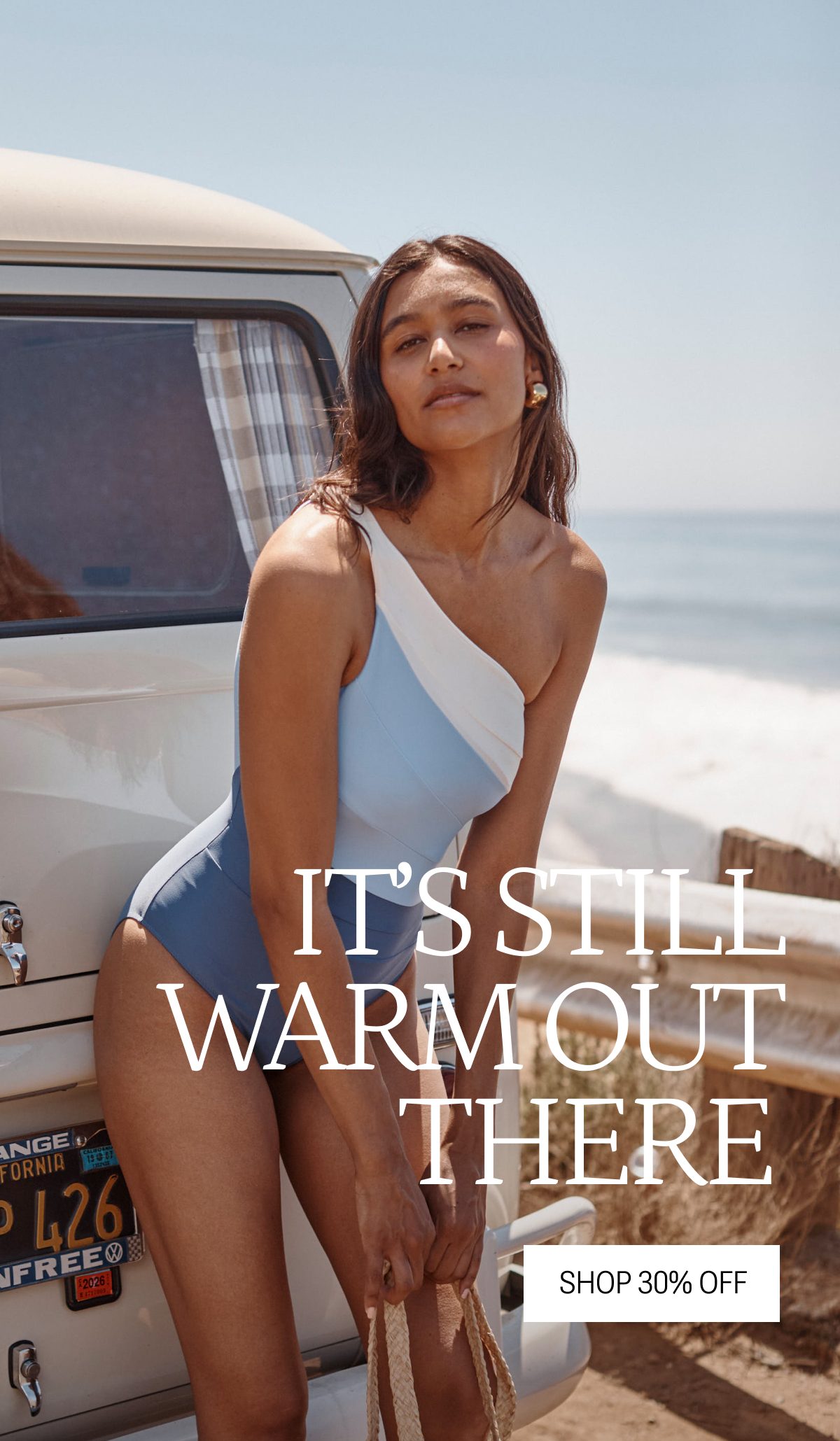 Model in blue and white one piece swimsuit