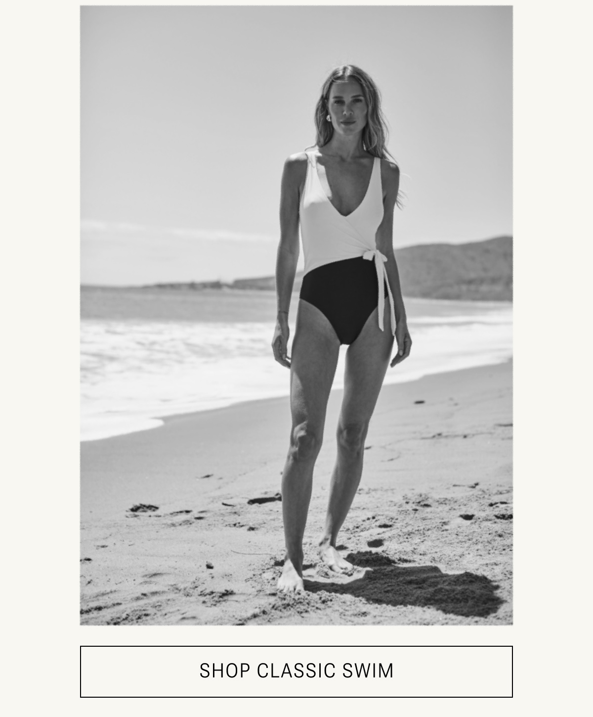 Model in black and white one piece swimsuit