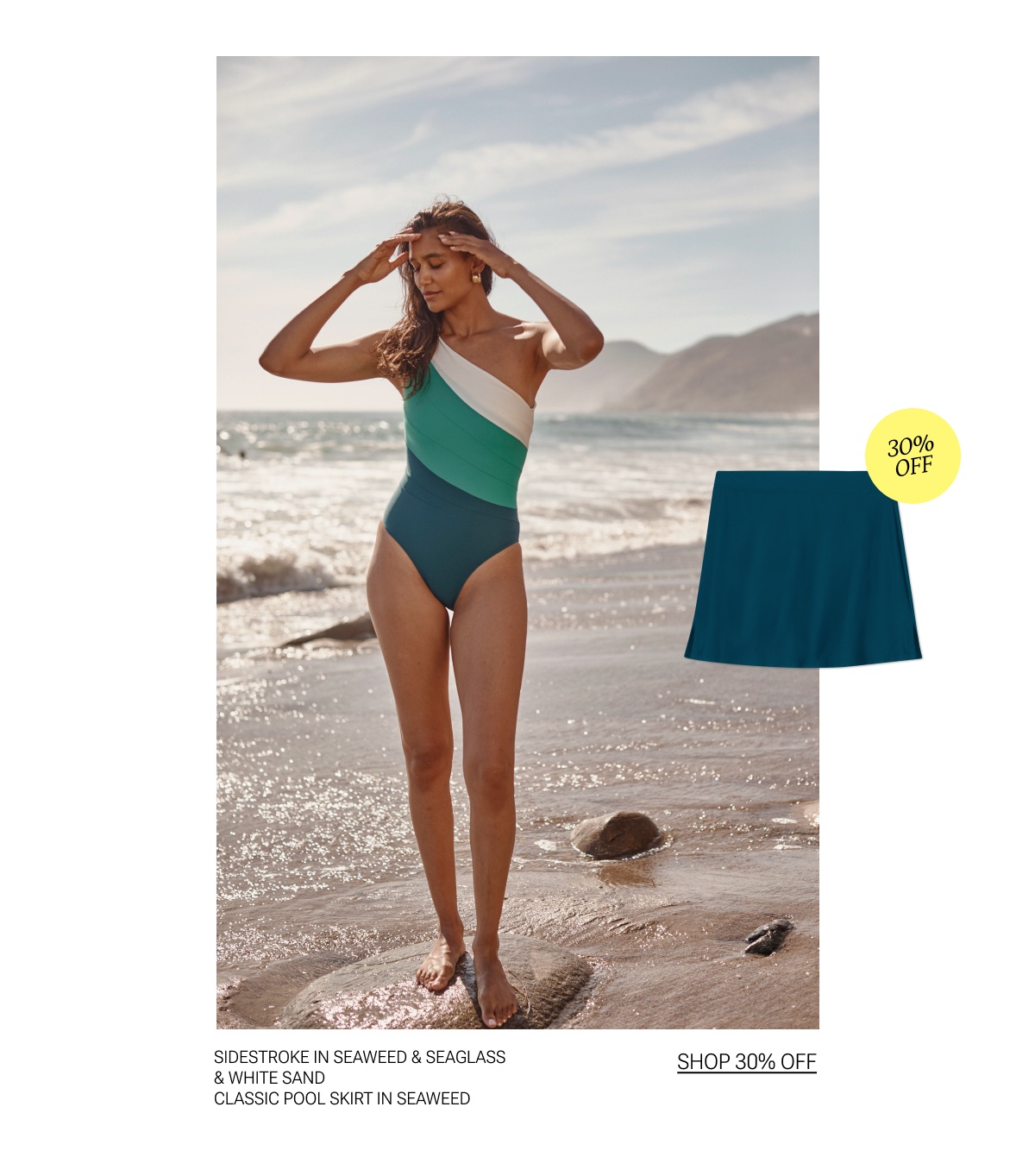 Model in blue, green, and white one piece swimsuit