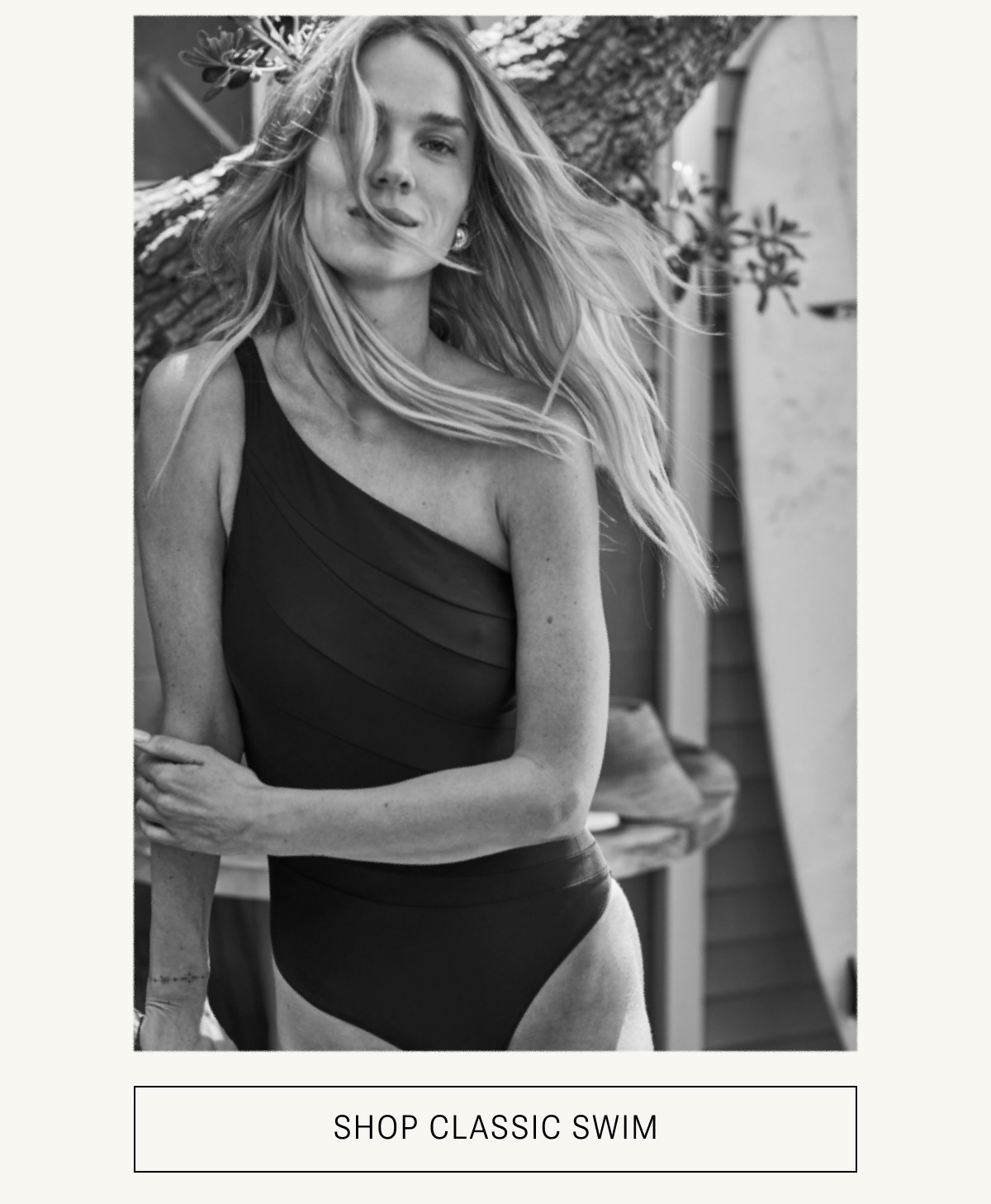 Model in black one piece swimsuit