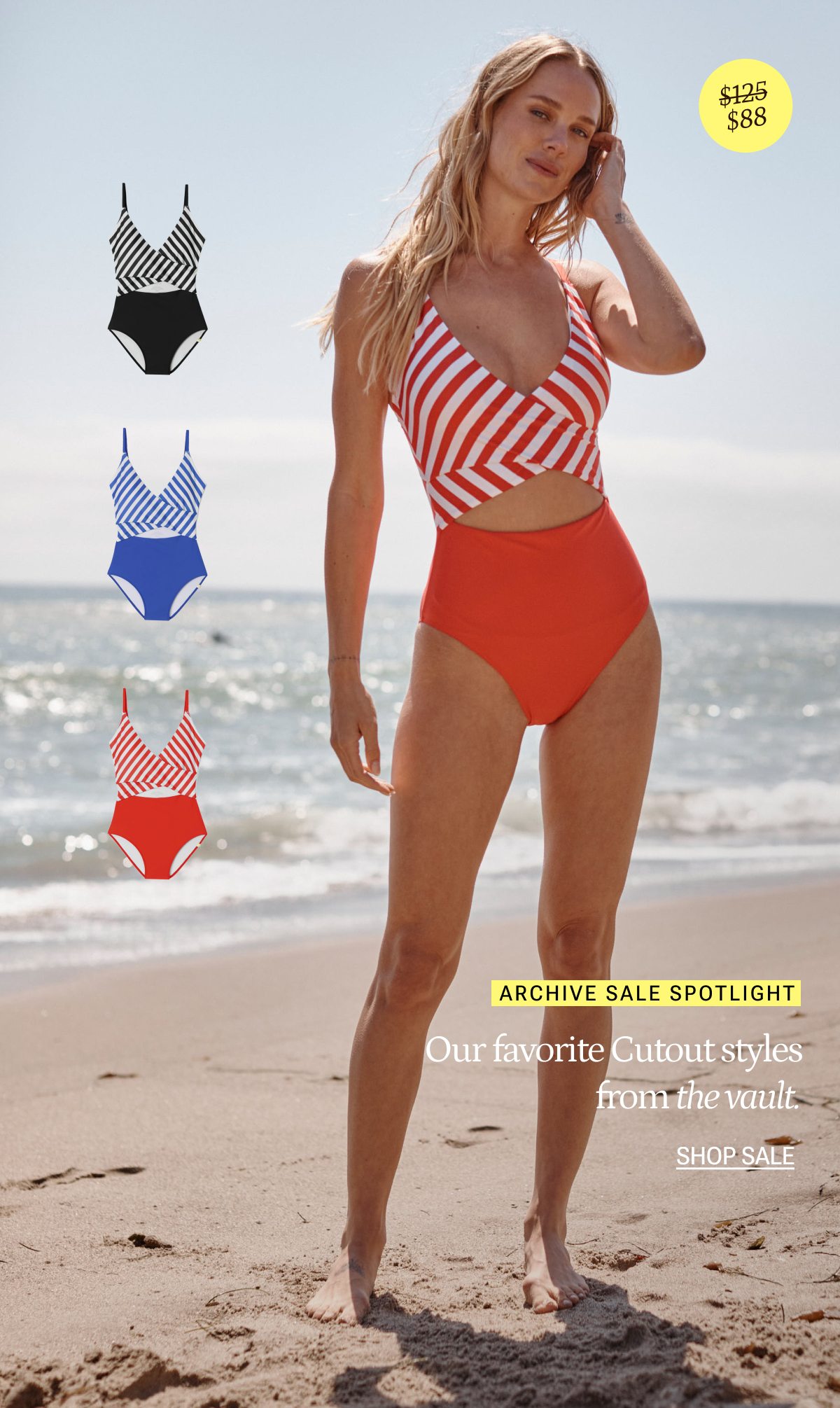 Model wearing a red & white striped cutout one piece swimsuit on the beach