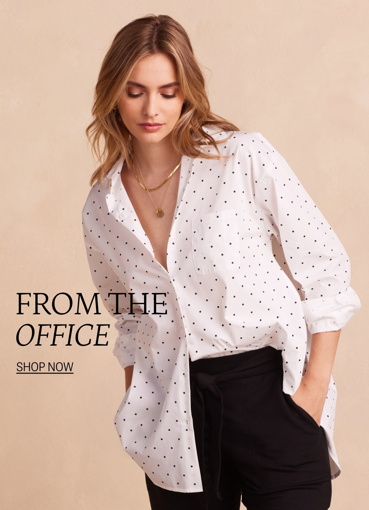 Model wearing a white and black pin dot button up shirt