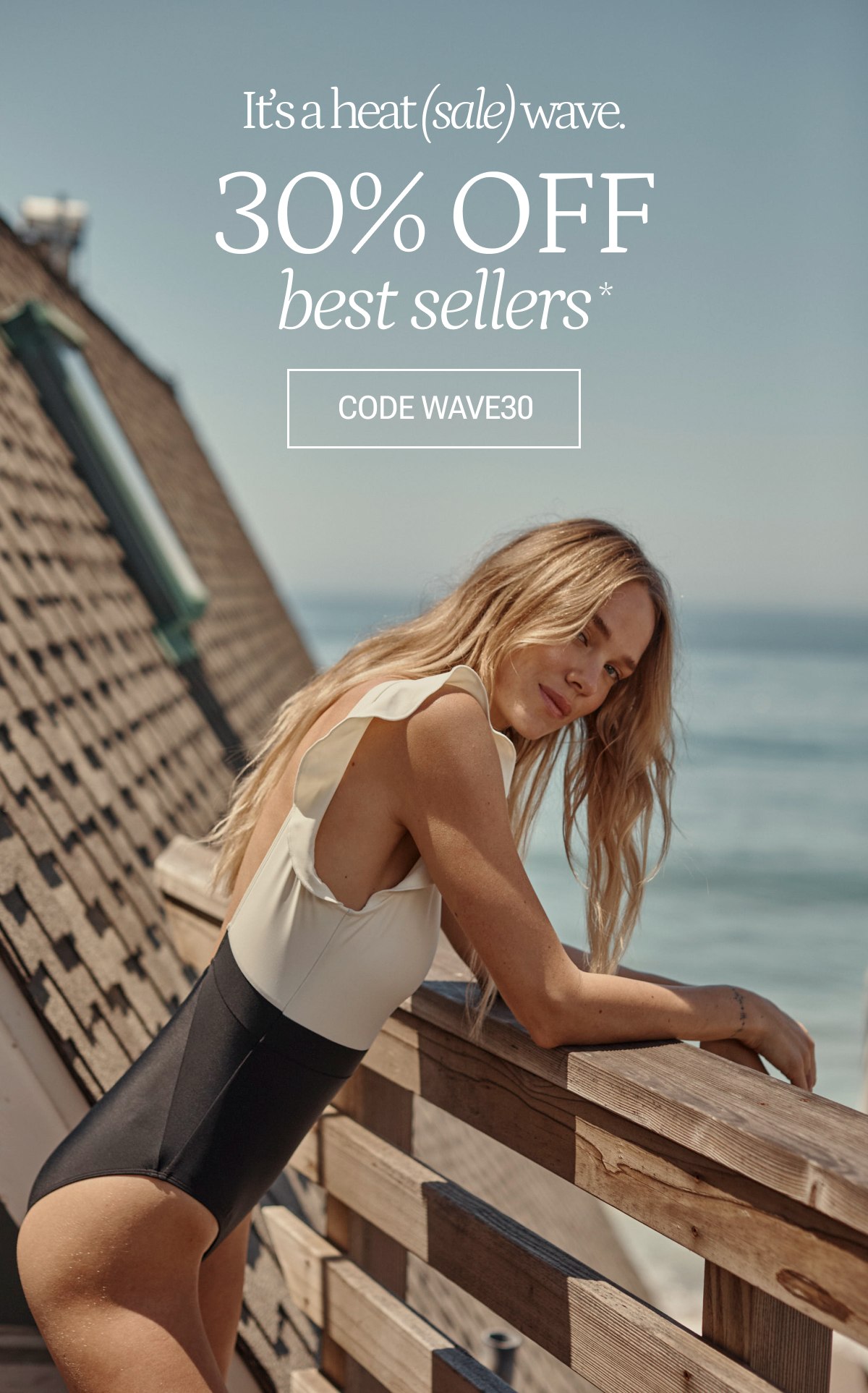 Model in black and white one piece swimsuit