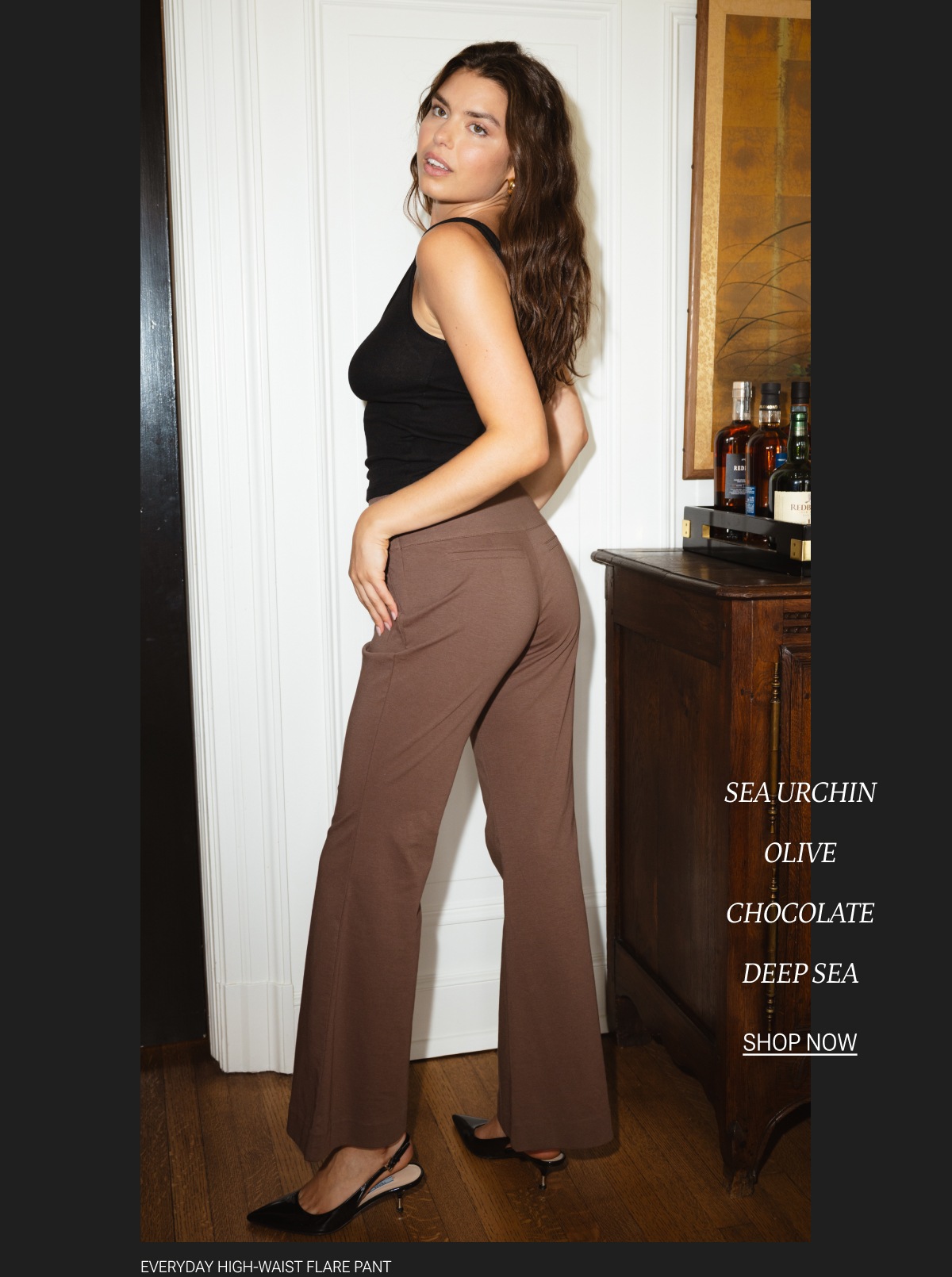 Model in black tank top and chocolate brown flare pants