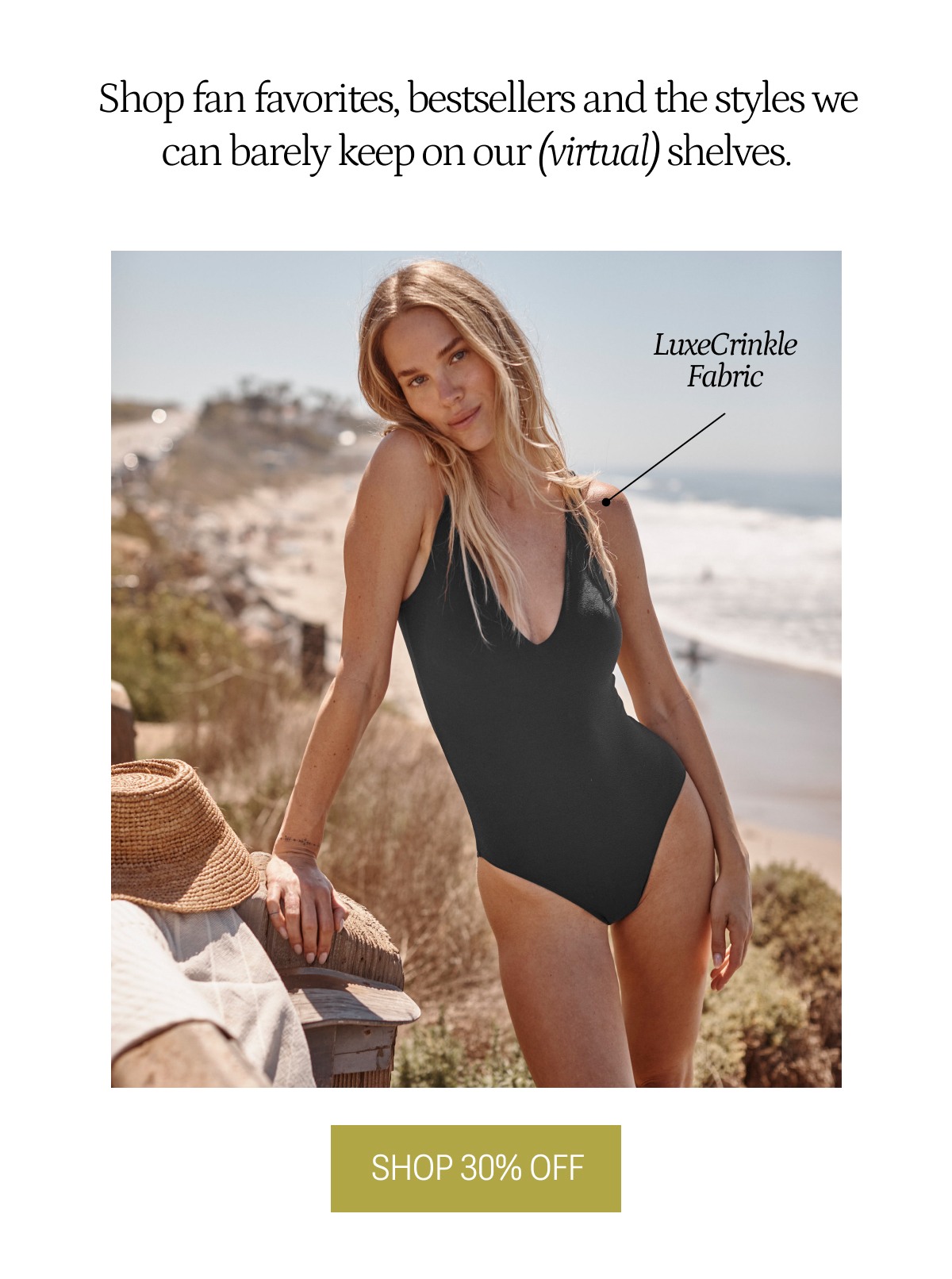 Model in black crinkle one piece swimsuit