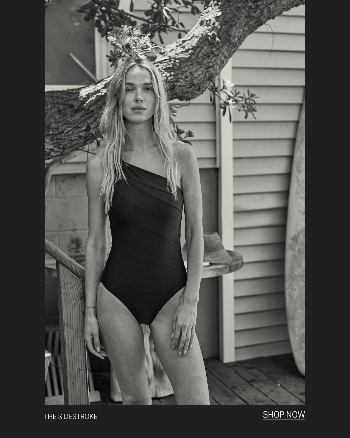Model in black and white one piece swimsuit