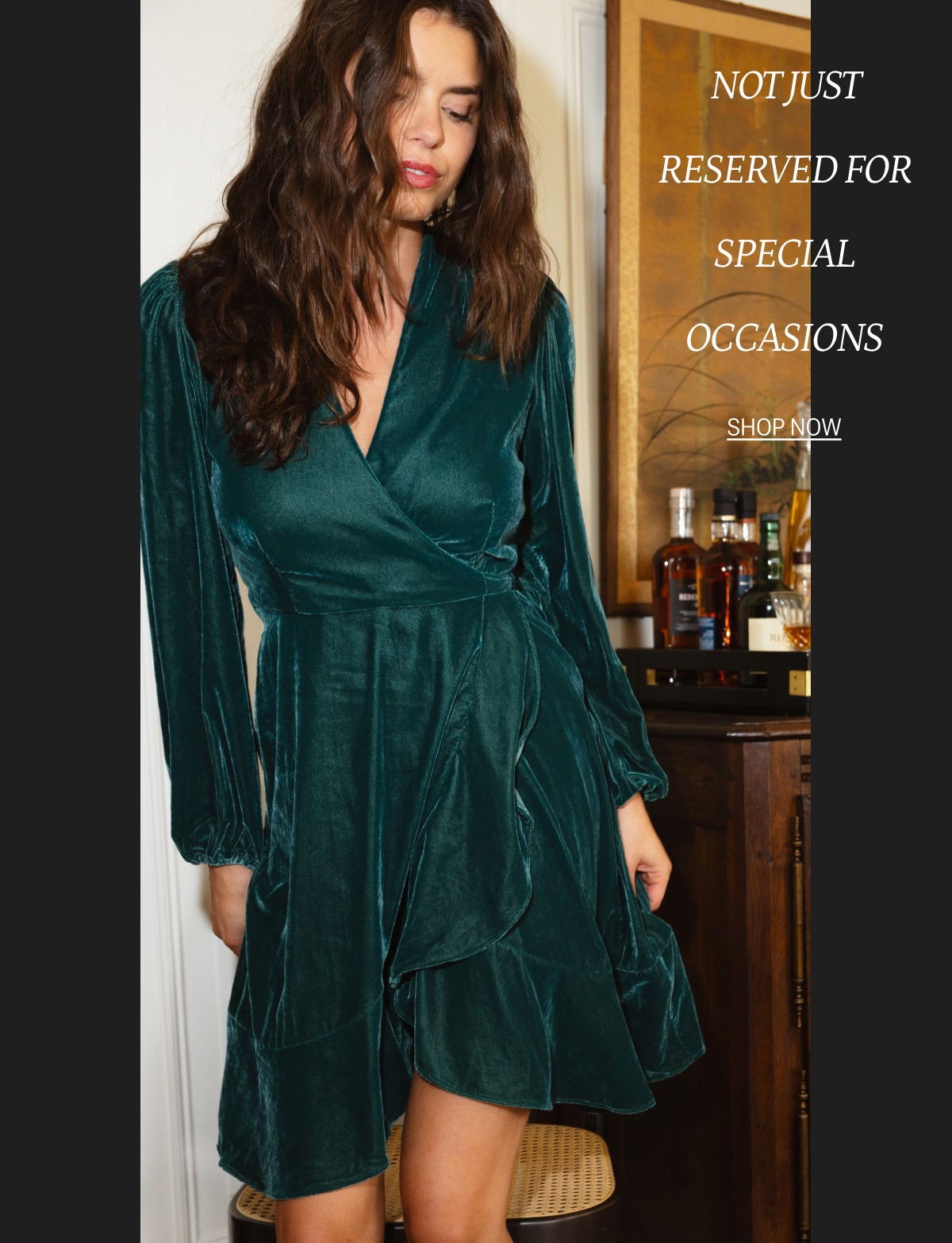 Model in green velvet wrap dress