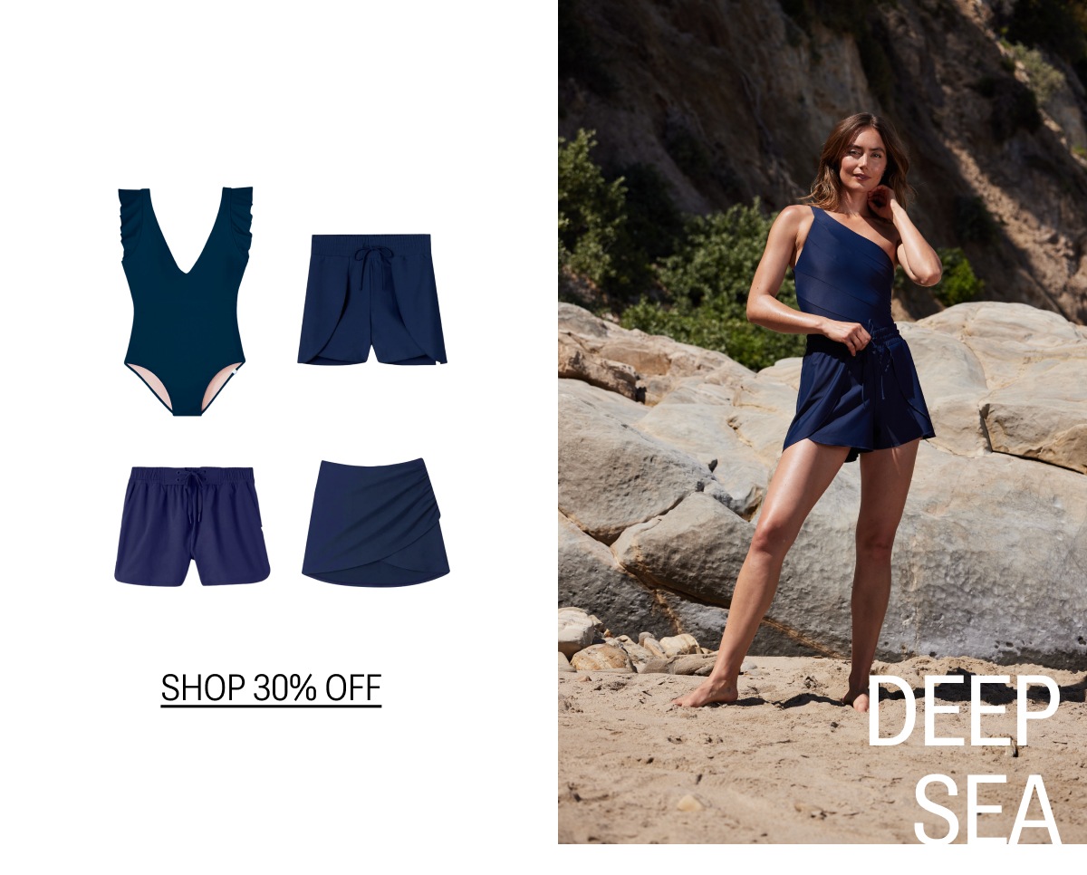 Model in navy blue one piece swimsuit