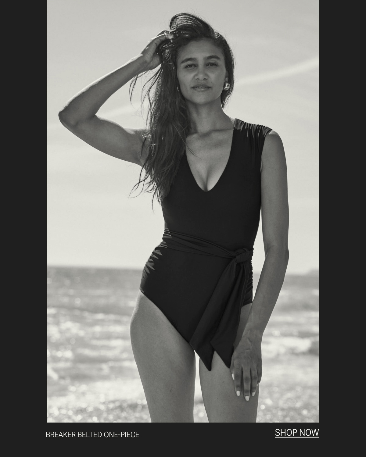 Model in black one piece swimsuit