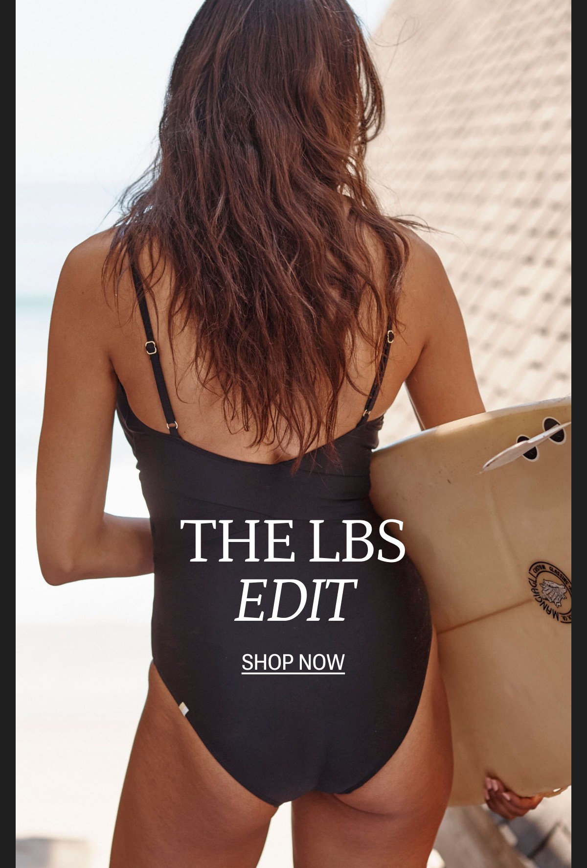 Model in black one piece swimsuit