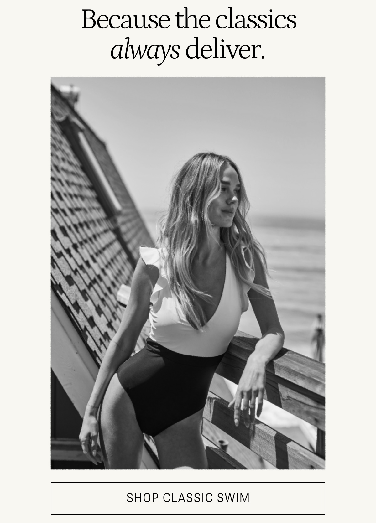 Model in black and white one piece swimsuit