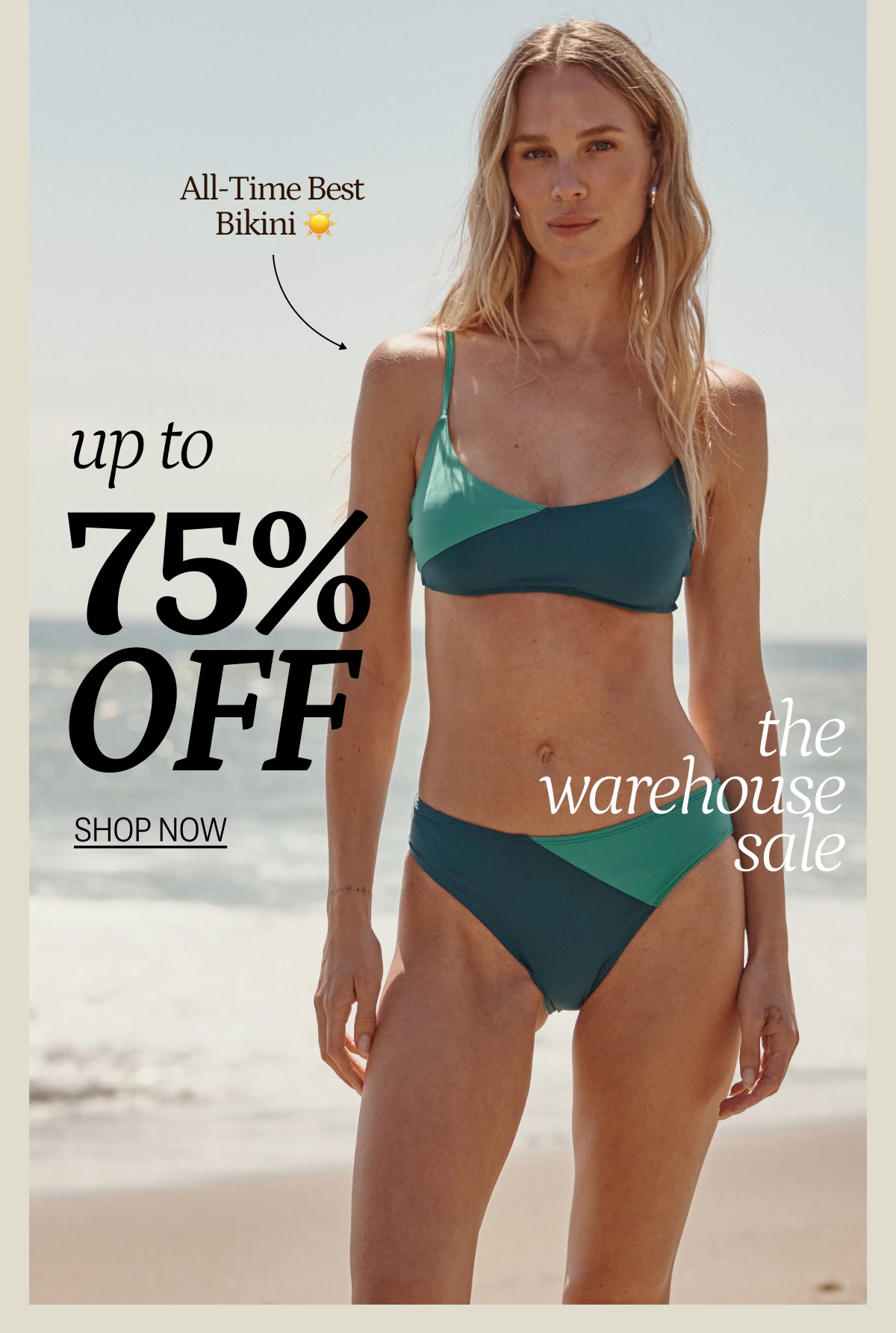 Model in matching green and blue bikini top and bottom on the beach