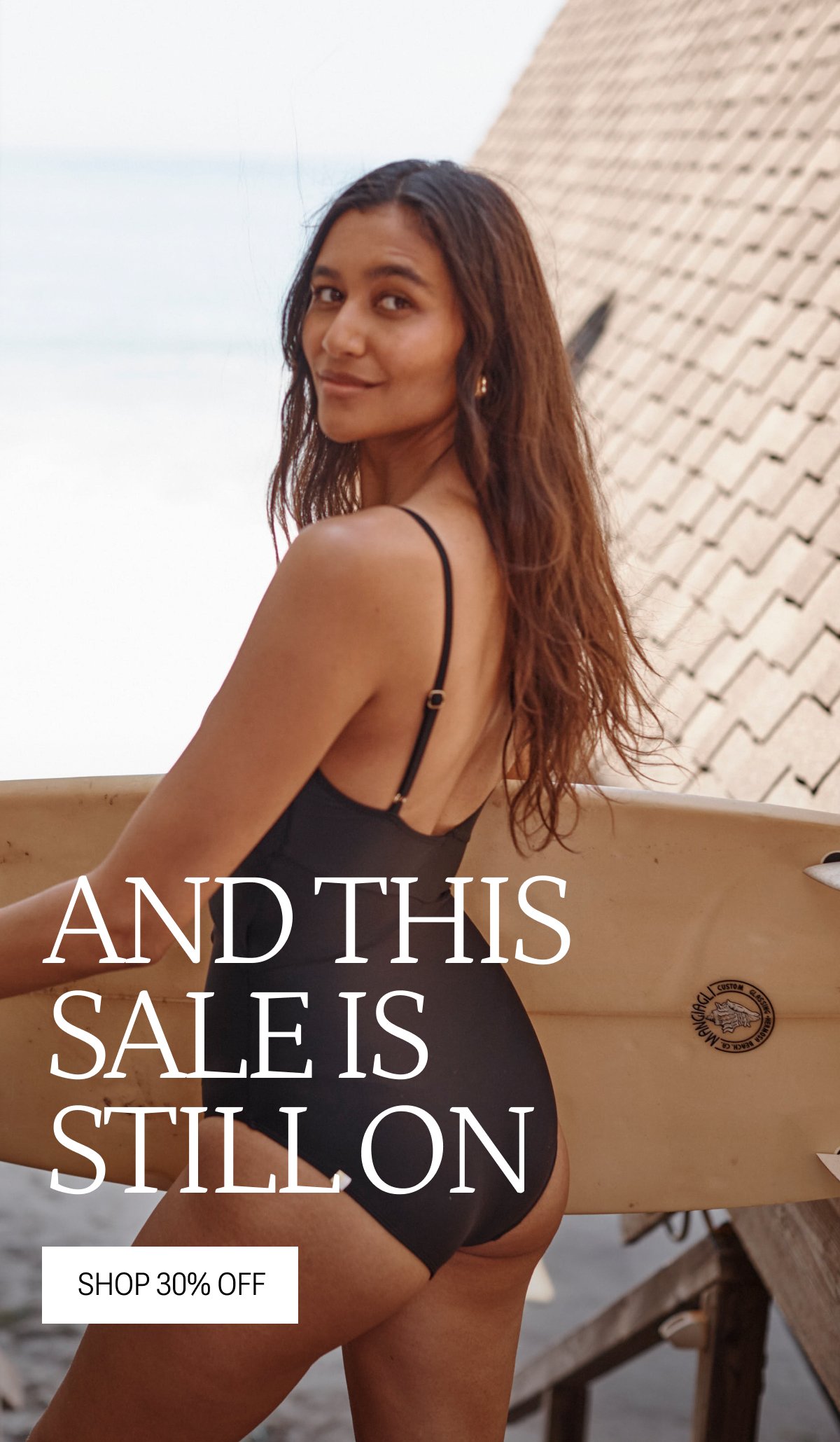 Model in black cutout one piece swimsuit