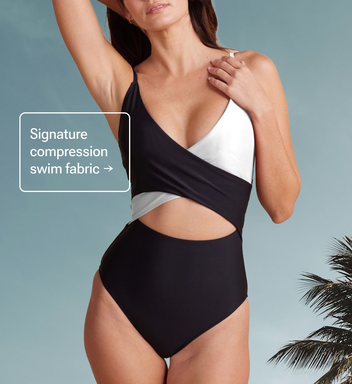 Model in black and white cutout one piece swimsuit