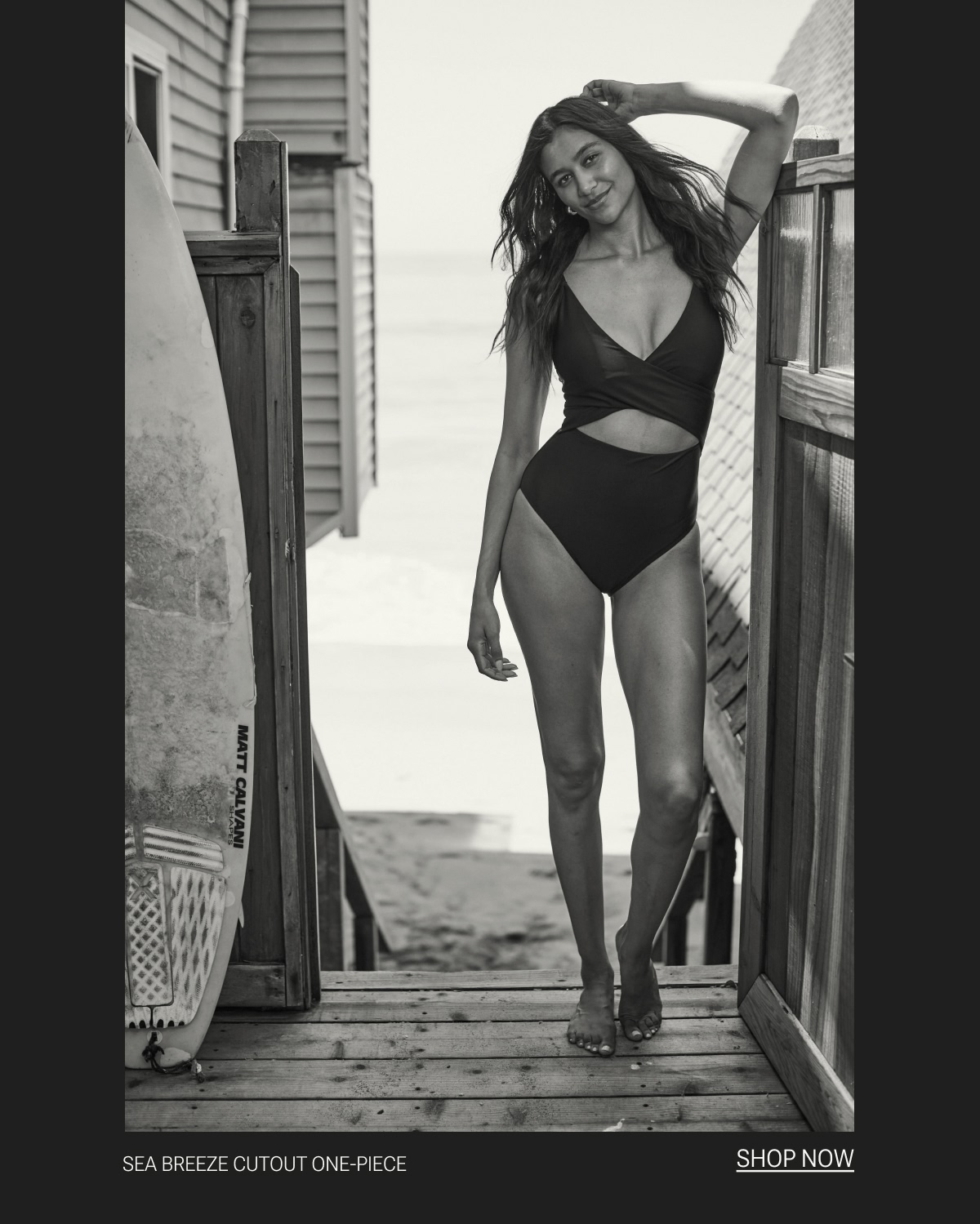 Model in black one piece swimsuit