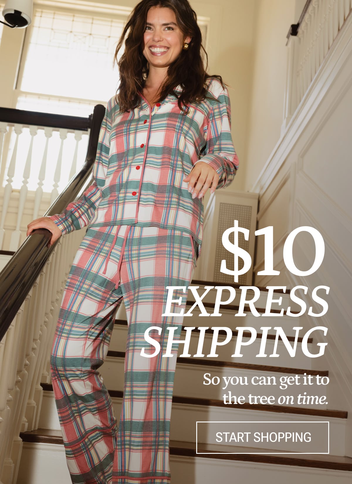 Model in holiday pajamas walking down the stairs