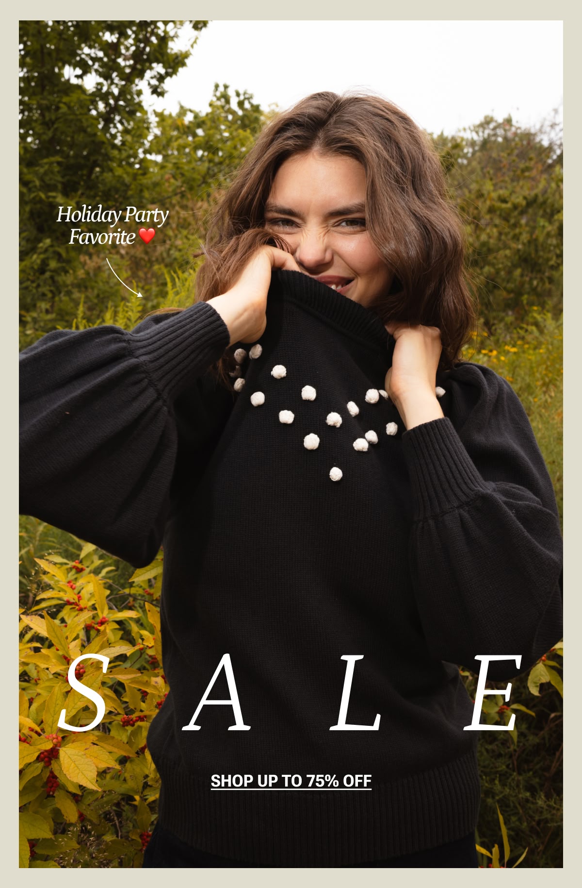 Model in black and white pompom cashmere sweater