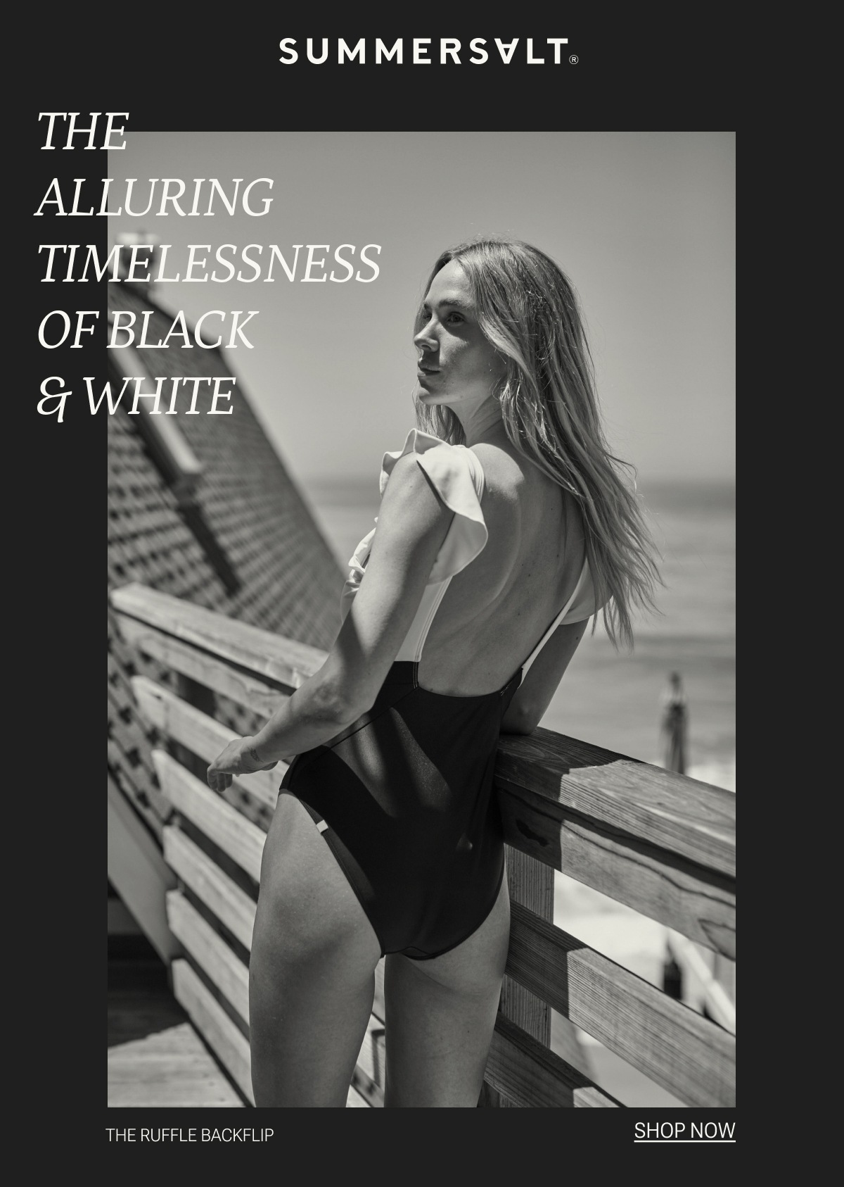 Model in black and white one piece swimsuit