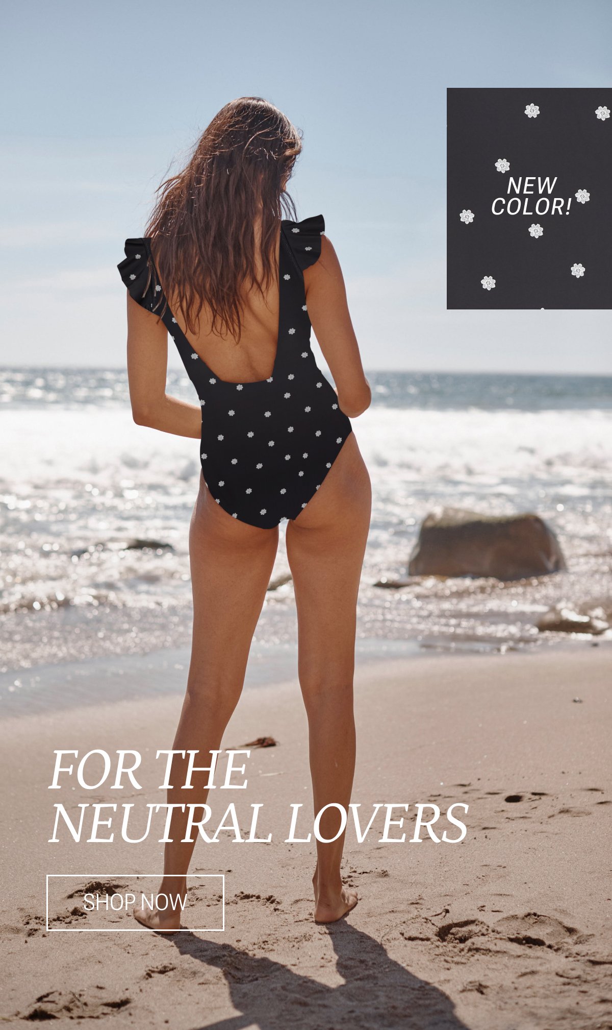 Model wearing a black and white tiny floral printed one piece swimsuit
