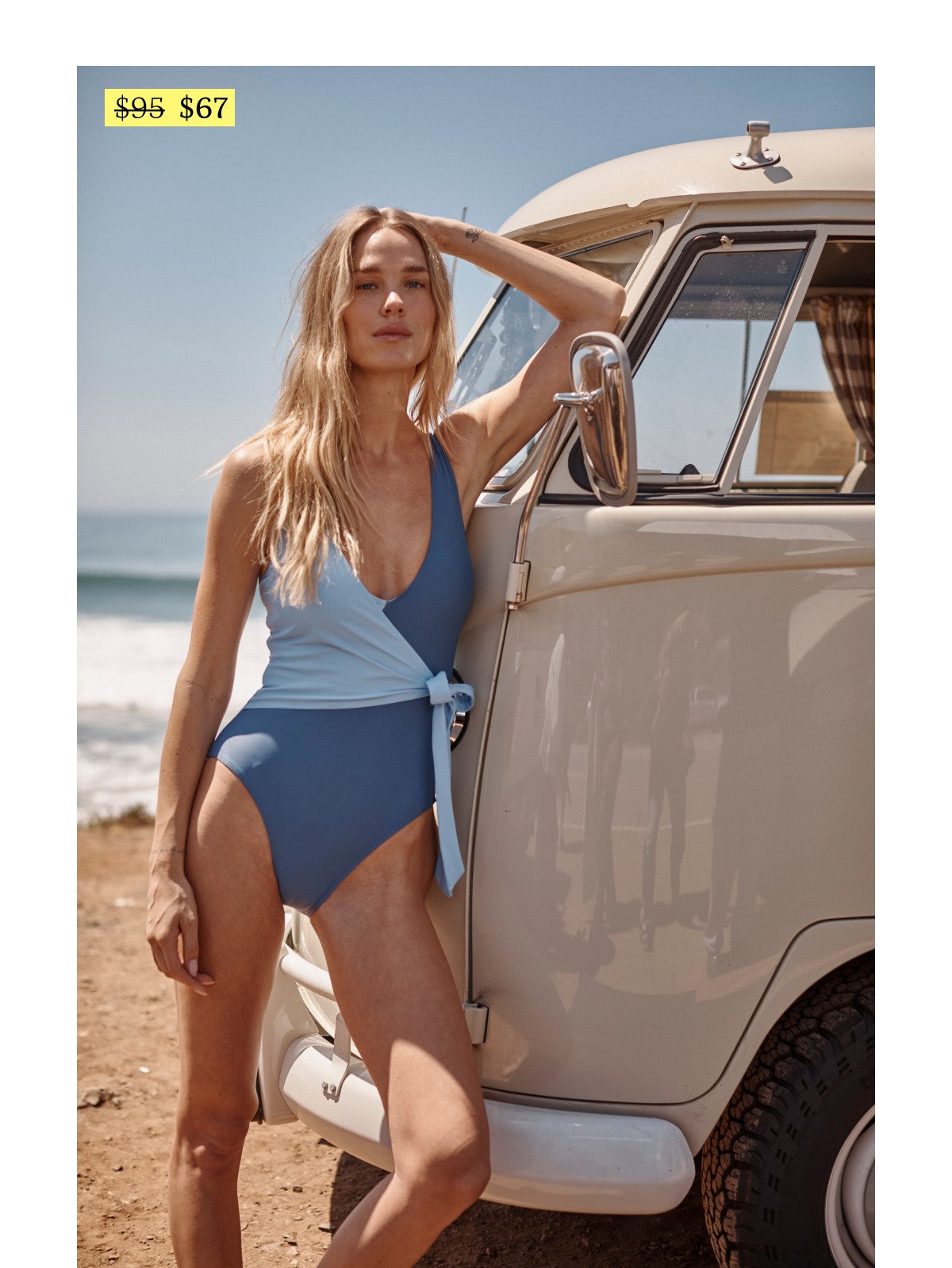Model wearing a blue wrap one piece swimsuit