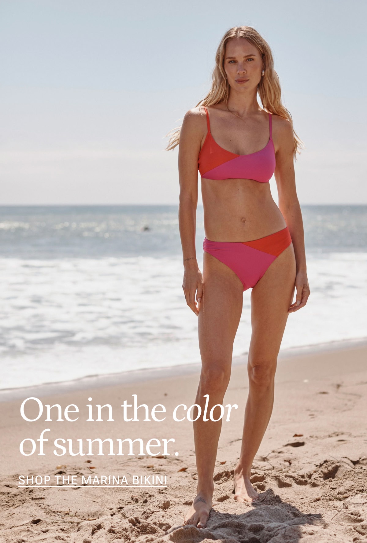 Model in pink and red bikini top and bottom