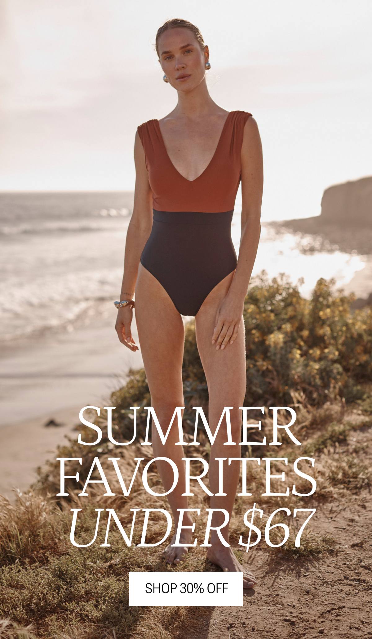 Model in black and brown colorblock one piece swimsuit