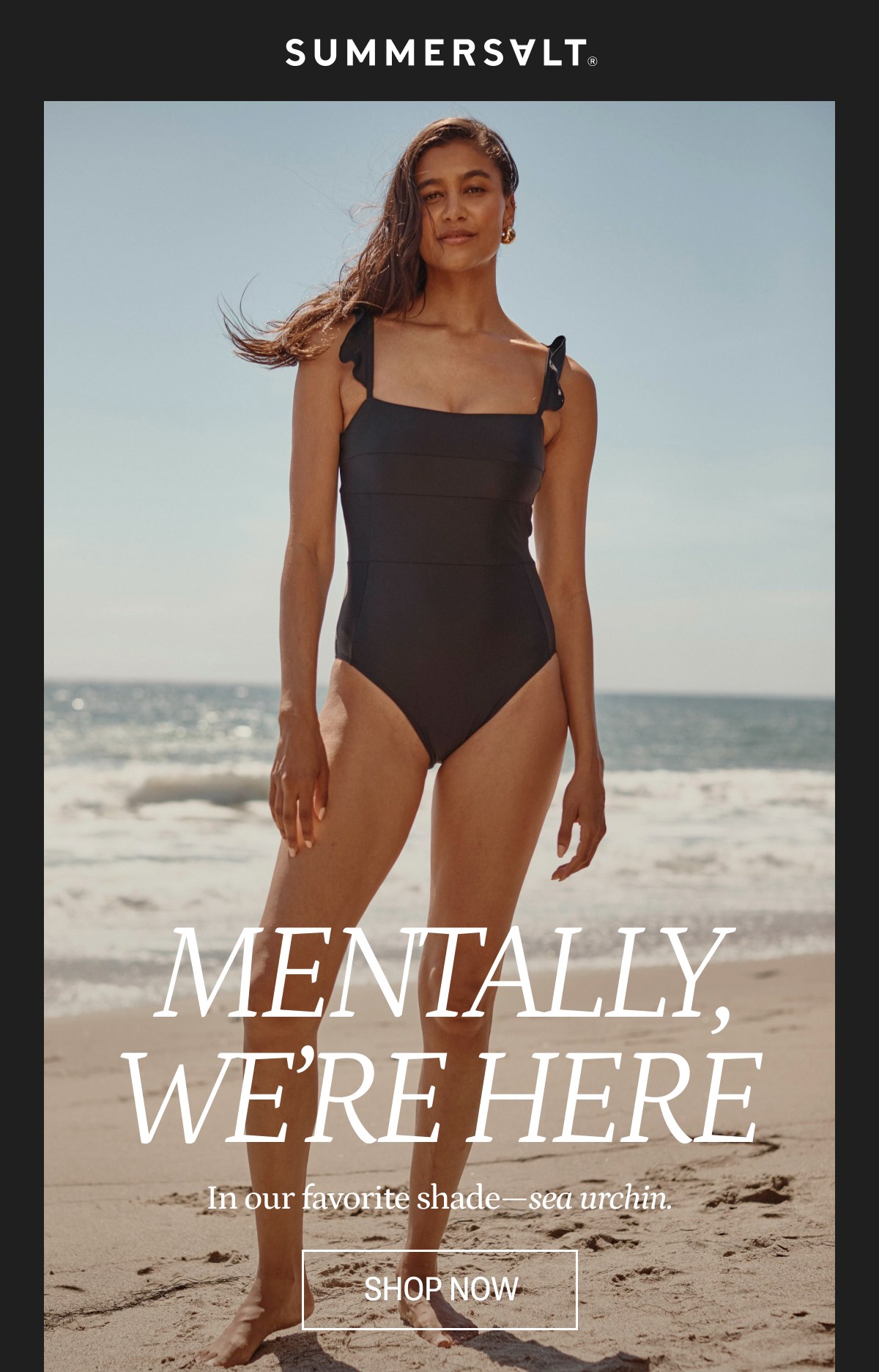 Model in black one piece swimsuit