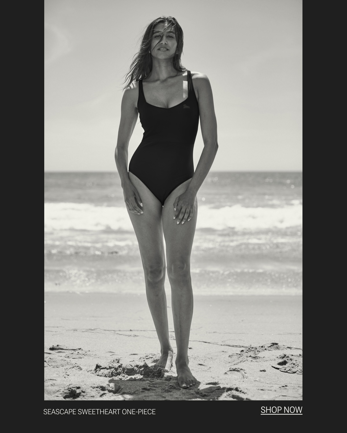 Model in black one piece swimsuit