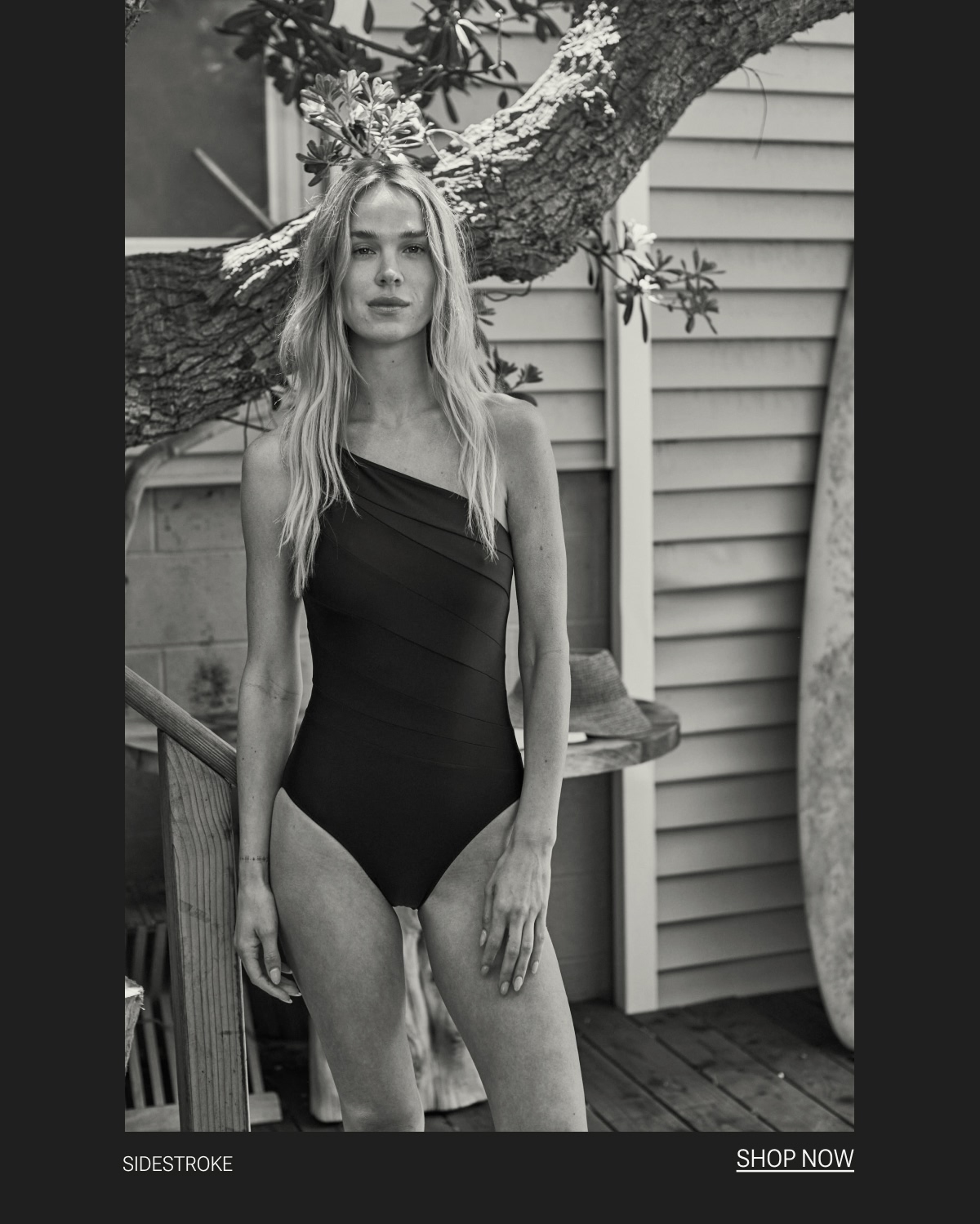Model in black one piece swimsuit