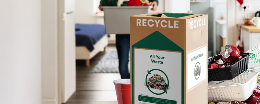 All-In-One Zero Waste Box displayed with waste in the background