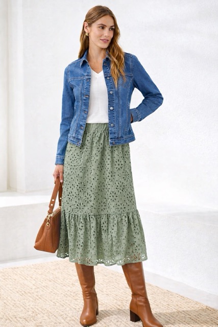 Woman styled in casual jean jacket and eyelet skirt