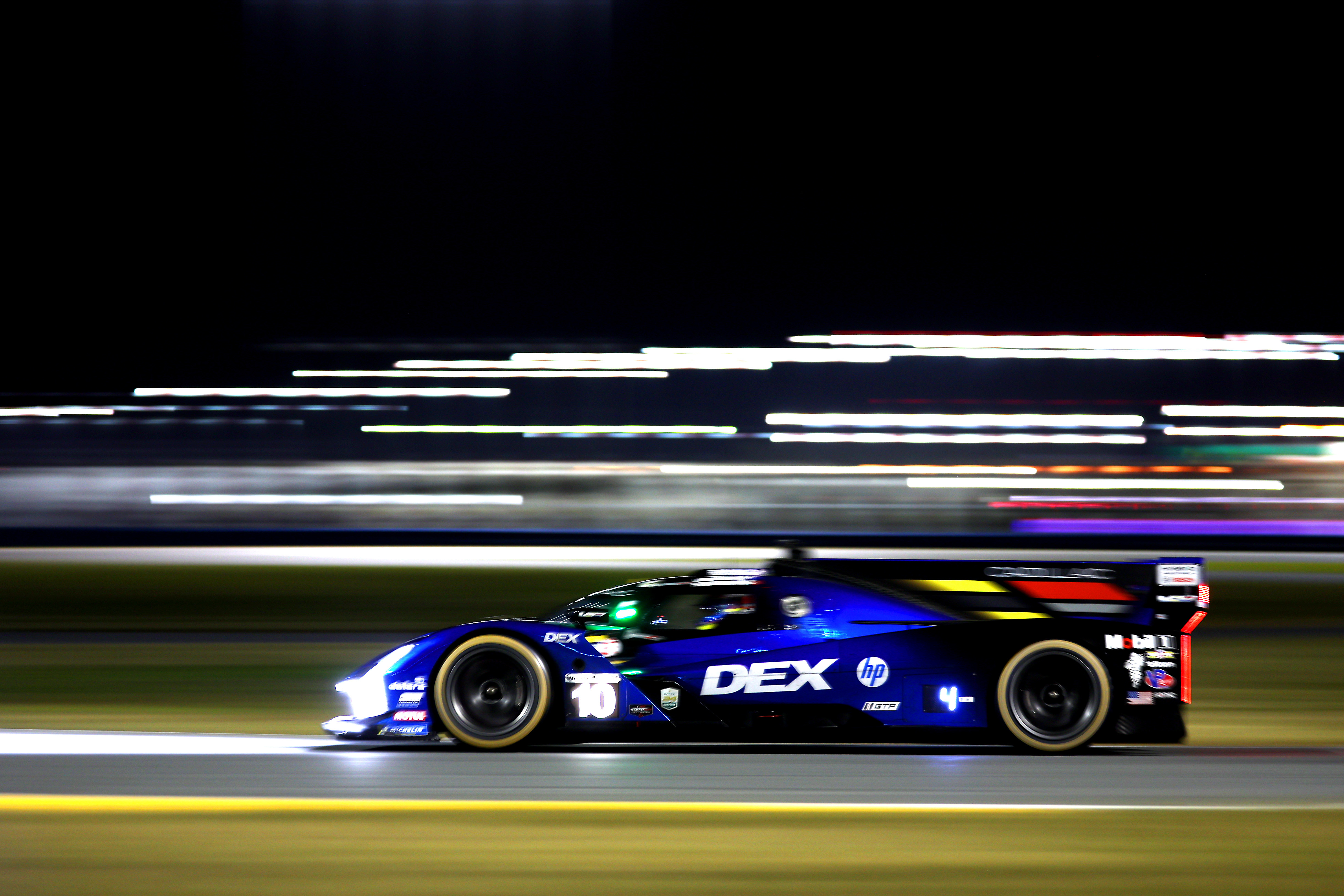 The #10 Cadillac Wayne Taylor Racing Cadillac on track and under the lights at the Rolex 24 hour event at Daytona International Speedway
