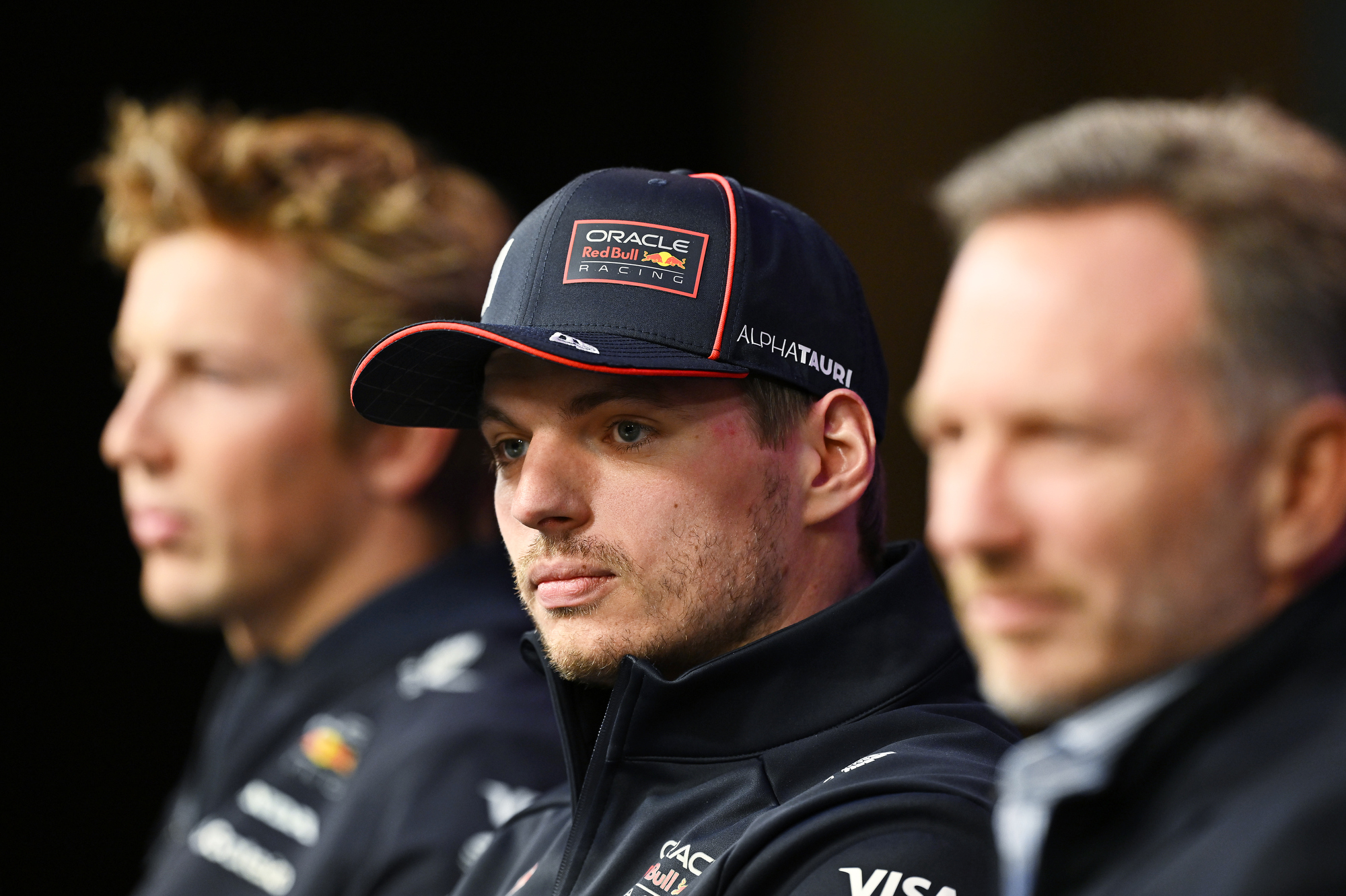 Max Verstappen, Red Bull Racing, sits between former teammate Liam Lawson and current Team Principal Christian Horner at the season launch, 2025