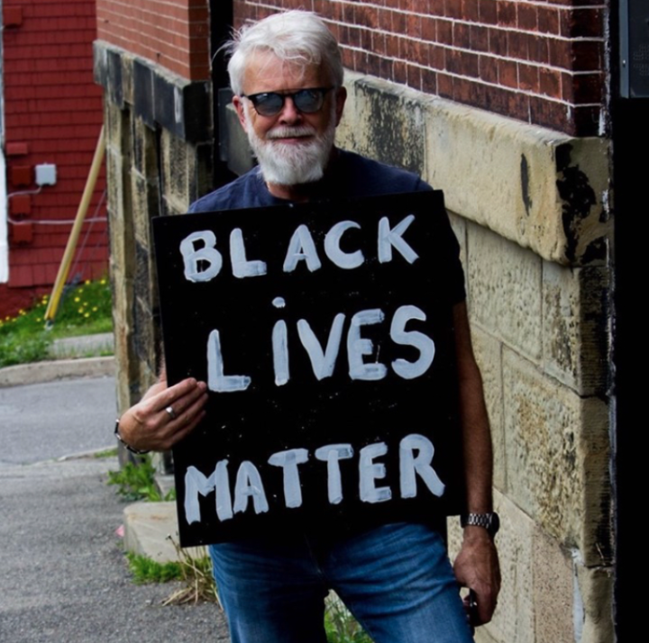 David holding up a BLM poster