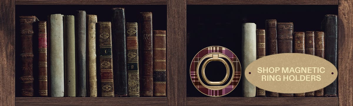 Bookshelves displaying books, with a magnetic ring holder and “Shop Magnetic Ring Holders” sign.