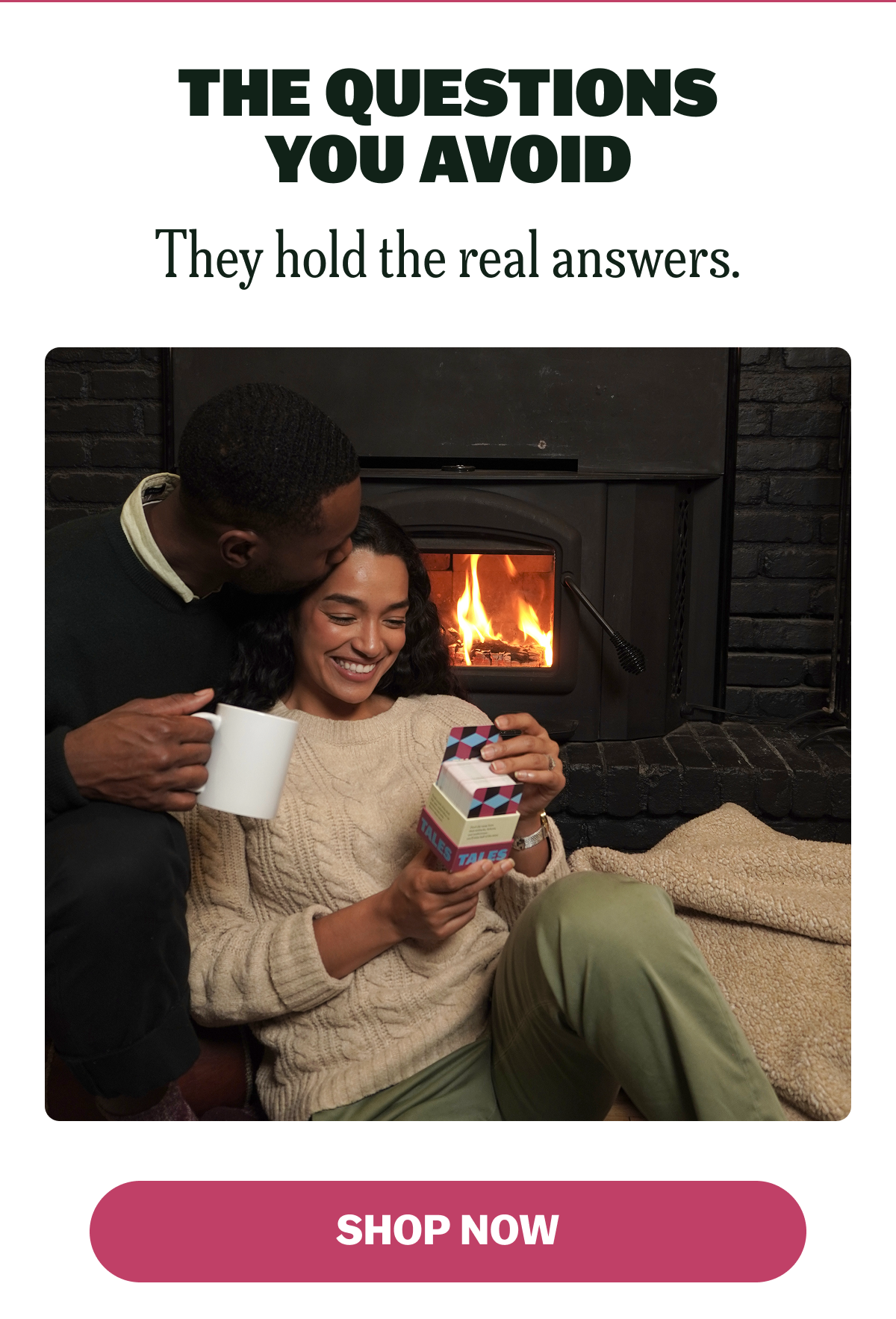 A couple by a fireplace, enjoying a cozy moment with a gift box.