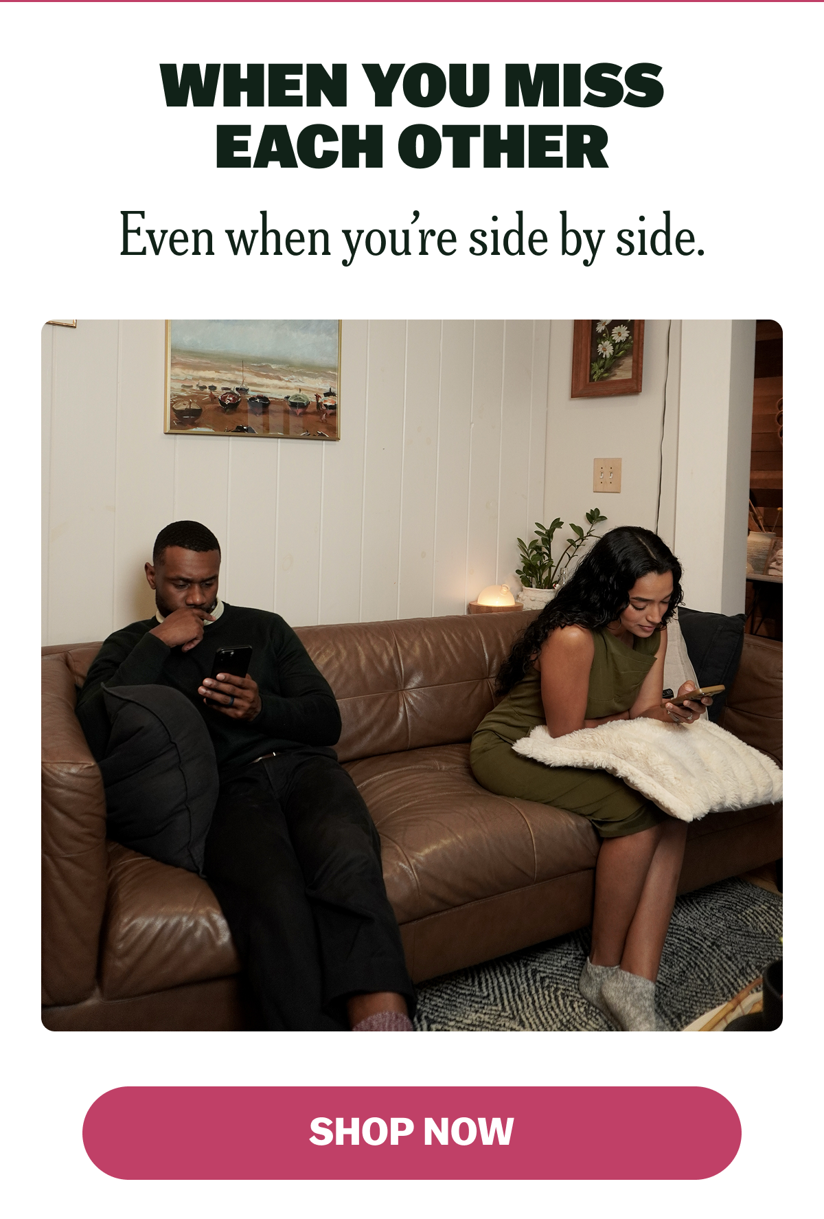 Two people sitting on a couch, each focused on their phones.