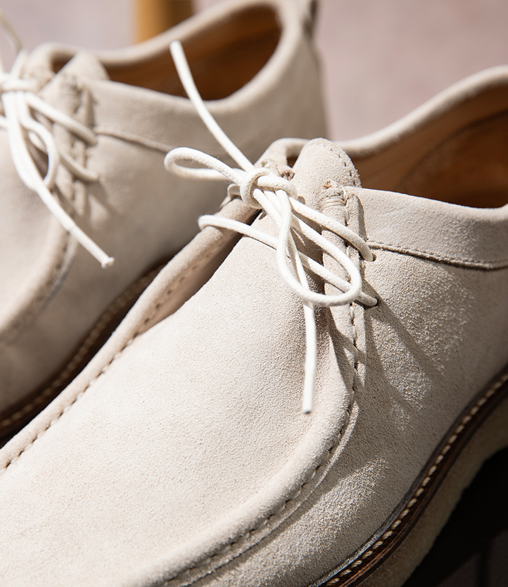 an image of a pair of white shoes with laces on them
