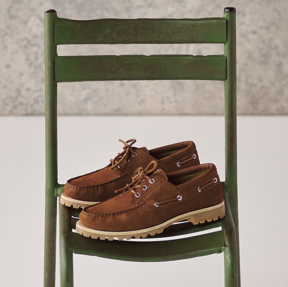 an image of a pair of brown shoes sitting on a green chair