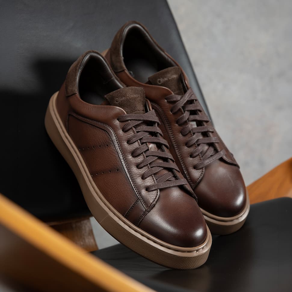 pair of cornillera brown trainers sat on a chair