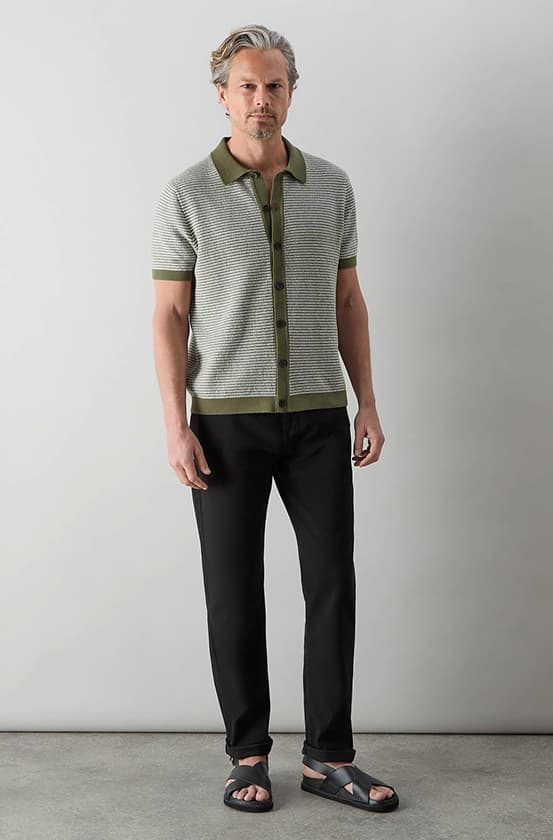 model wearing knitted shirt, chinos and leather sandals
