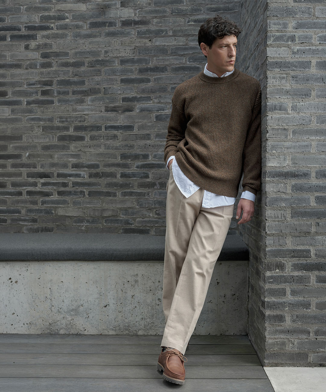 lambswool brown jumper with a white shirt underneath and beige trousers