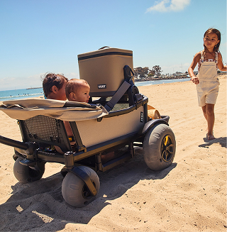 Kids riding in Veer Cruiser on beach