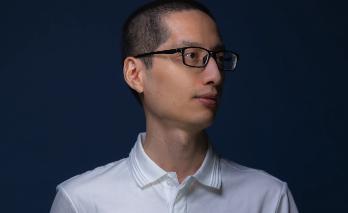 A portrait photograph of Tixiao Shan looking off-camera