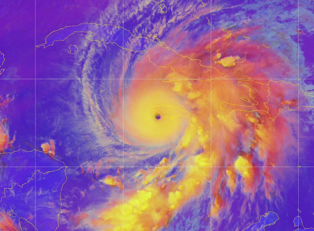 A color enhanced view of Hurricane Melissa--the clouds are in yellow and oranges, all on a purple background.